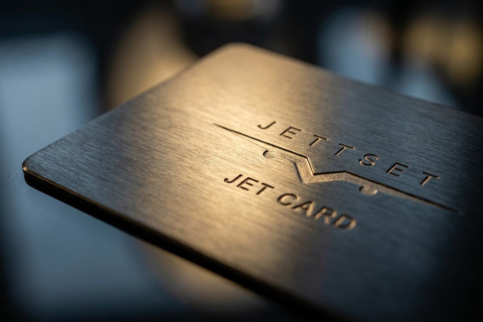 Macro shot of the brushed metal Jettset Jet Card with engraved logo, Jettset Global Jet Card membership programme for frequent flyers